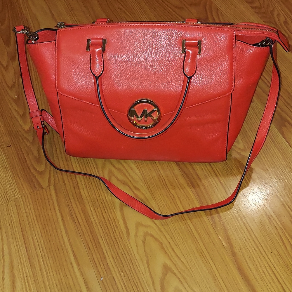 Chic and versatile bag . Michael kors satchel in bold tomato with gold accents.